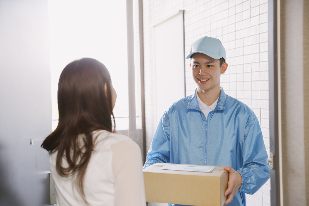 A smiling business owner handing a package to a delighted customer, symbolizing exceptional customer service and loyalty.